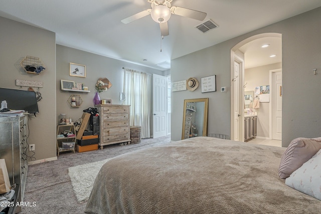 carpeted bedroom with connected bathroom and ceiling fan