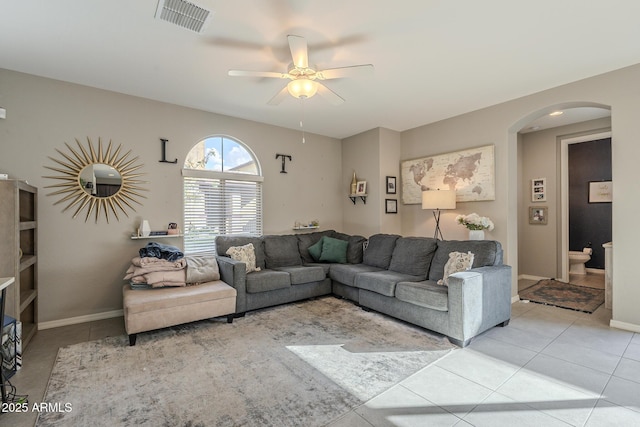 tiled living room featuring ceiling fan