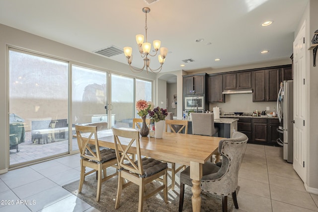 dining area with light tile patterned floors, a notable chandelier, and a wealth of natural light