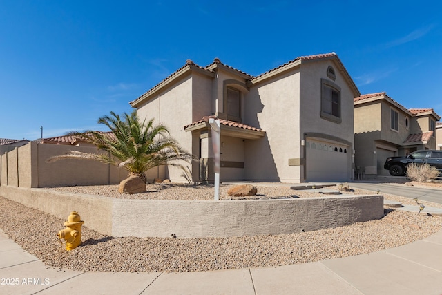 mediterranean / spanish-style house with a tile roof, stucco siding, fence, a garage, and driveway