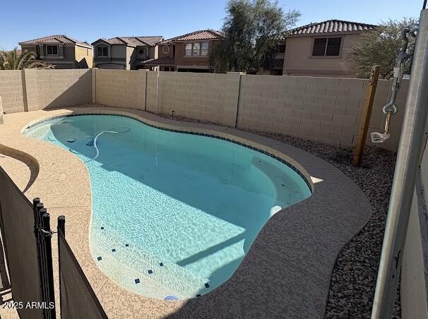 view of pool with a residential view, a fenced backyard, and a fenced in pool