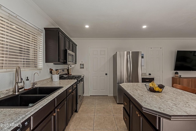 kitchen with light tile patterned floors, appliances with stainless steel finishes, light countertops, crown molding, and a sink