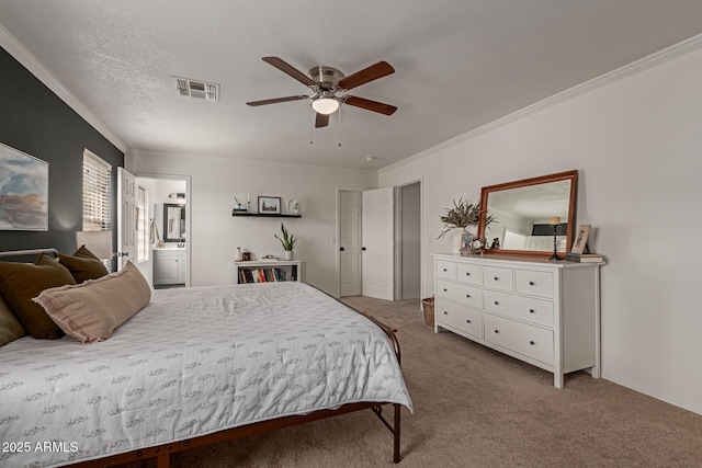 bedroom with visible vents, ensuite bath, ceiling fan, ornamental molding, and carpet floors