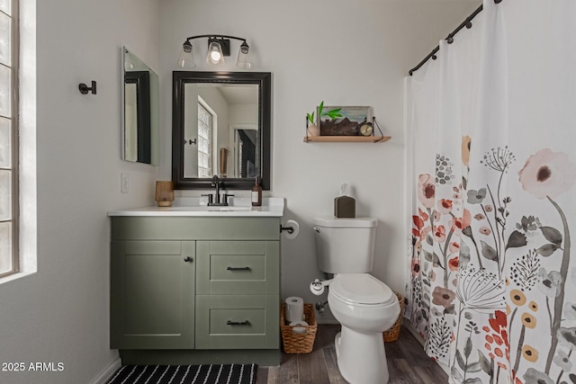 bathroom featuring vanity, curtained shower, wood finished floors, and toilet