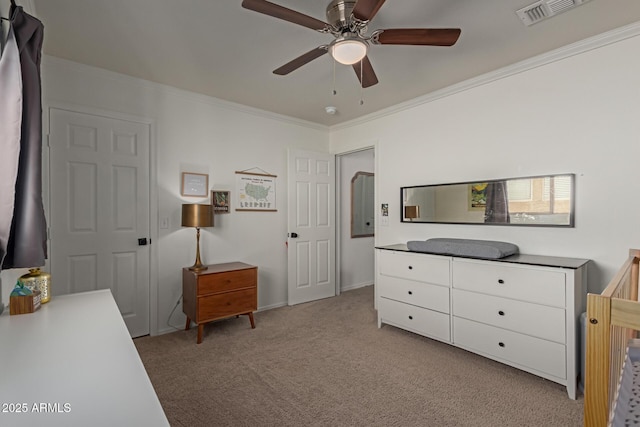 bedroom with ornamental molding, visible vents, ceiling fan, and light carpet