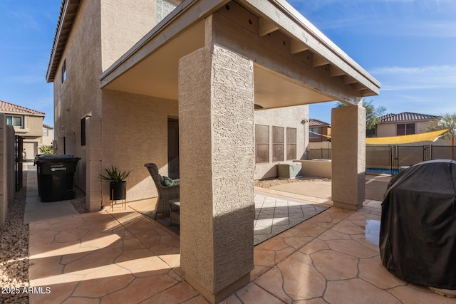 view of patio featuring fence and grilling area