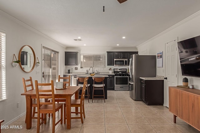 dining area featuring visible vents, crown molding, baseboards, and light tile patterned flooring