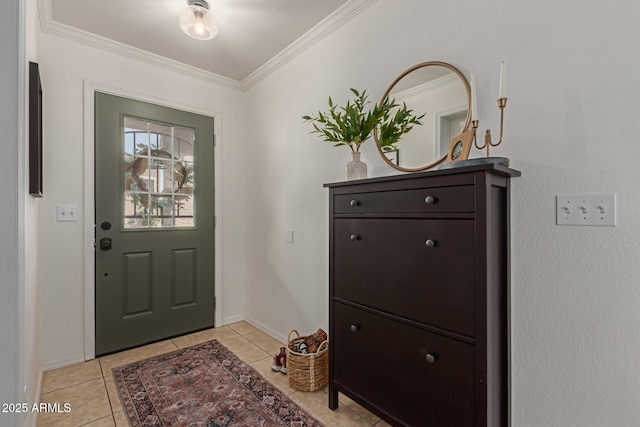 foyer entrance with baseboards, light tile patterned flooring, and crown molding