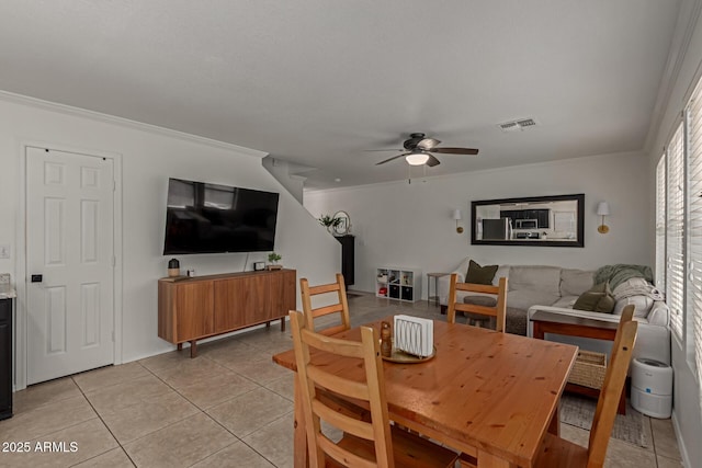 dining area with light tile patterned floors, ceiling fan, and ornamental molding