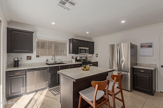 kitchen featuring light tile patterned floors, visible vents, appliances with stainless steel finishes, light countertops, and a sink