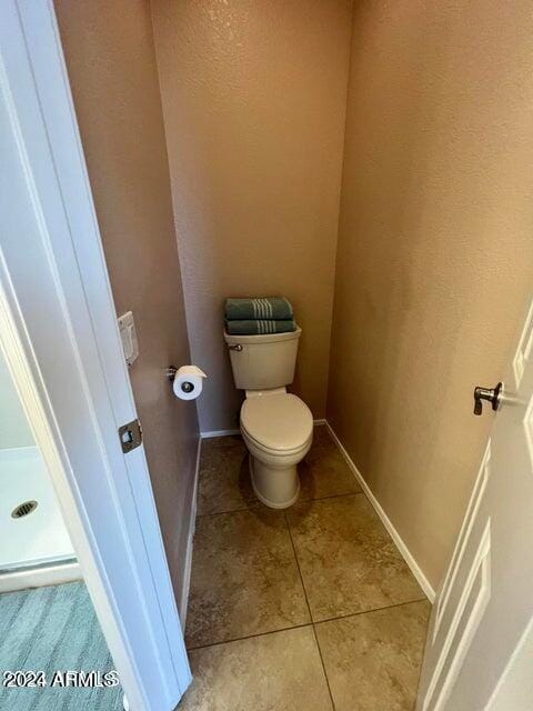 bathroom with tile patterned flooring and toilet