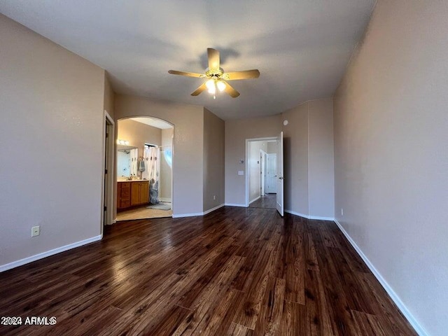 unfurnished room featuring ceiling fan and dark hardwood / wood-style flooring