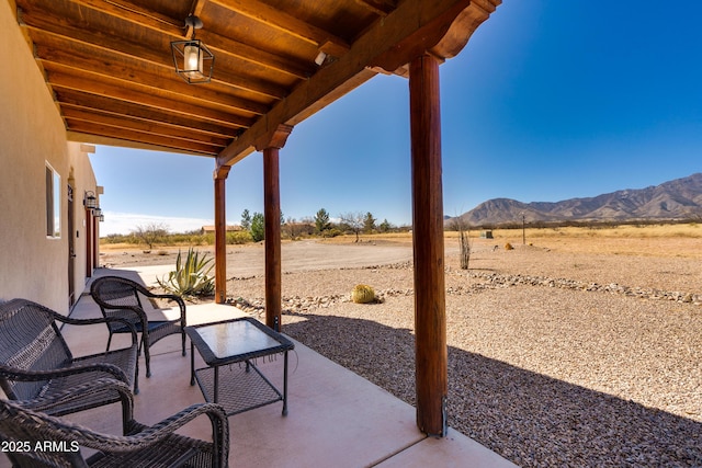 view of patio / terrace featuring a mountain view