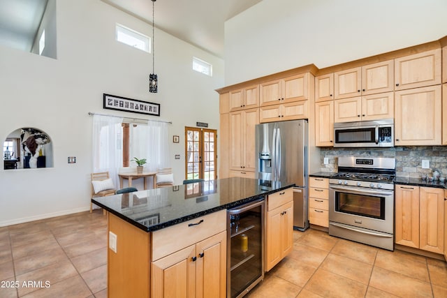 kitchen with stainless steel appliances, beverage cooler, and light brown cabinets