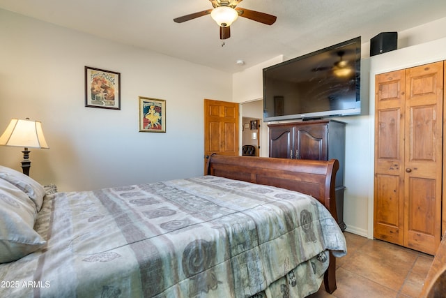 bedroom featuring a ceiling fan and tile patterned flooring