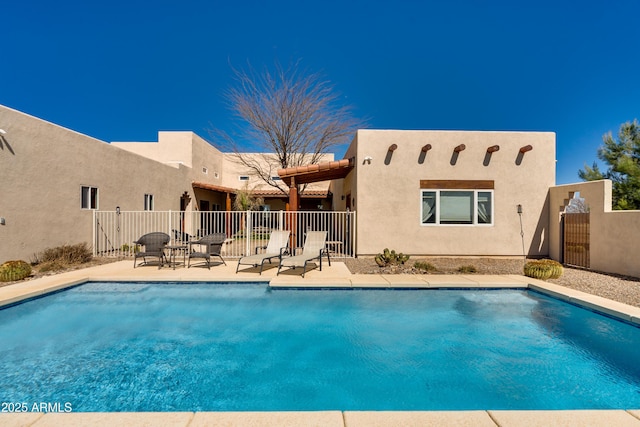 view of swimming pool featuring a fenced in pool, a patio, and fence