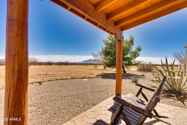 view of yard with a mountain view and a patio