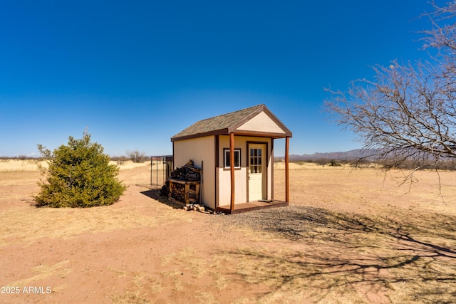 view of outbuilding featuring an outdoor structure and a rural view