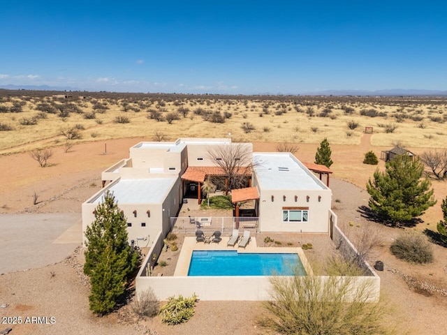 drone / aerial view featuring a desert view and a rural view