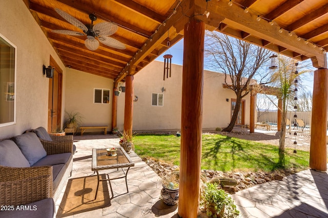 view of patio / terrace with outdoor lounge area, ceiling fan, and fence