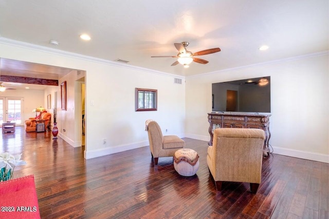 living room with ceiling fan, dark hardwood / wood-style flooring, and ornamental molding