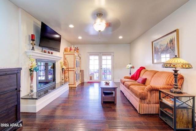 living room featuring ceiling fan, french doors, and dark hardwood / wood-style floors