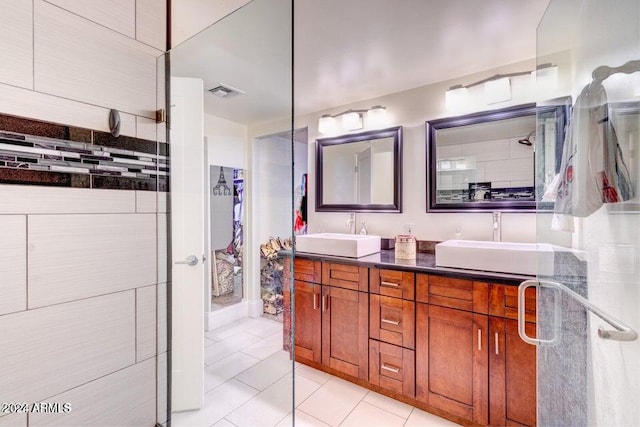 bathroom featuring vanity, tile patterned floors, and a shower with shower door