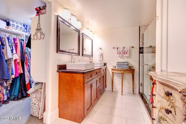 bathroom with vanity, a shower with door, and tile patterned flooring