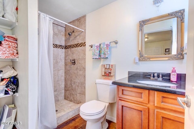 bathroom with walk in shower, wood-type flooring, vanity, and toilet