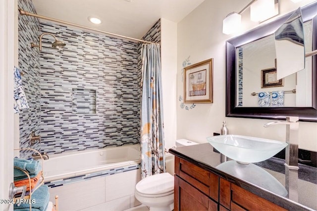 full bathroom with toilet, shower / tub combo with curtain, and vanity