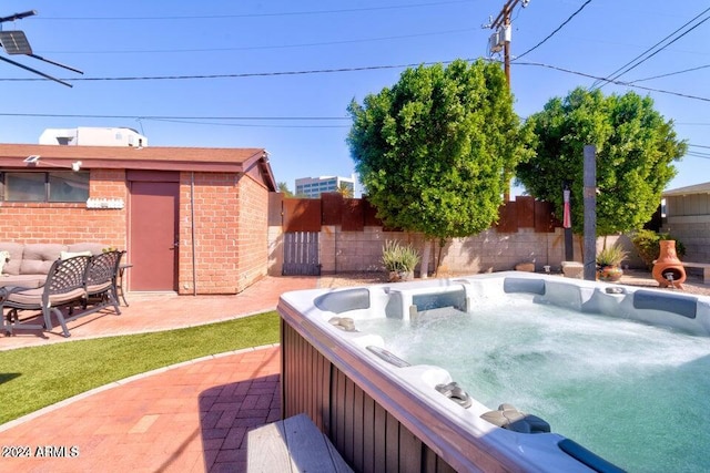 exterior space with a hot tub