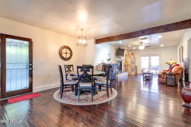 dining room with dark hardwood / wood-style flooring, beamed ceiling, a chandelier, and french doors