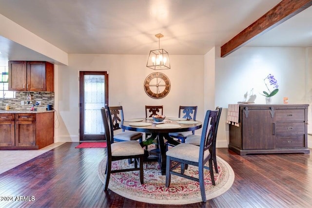 dining room featuring beam ceiling, dark hardwood / wood-style flooring, and a notable chandelier