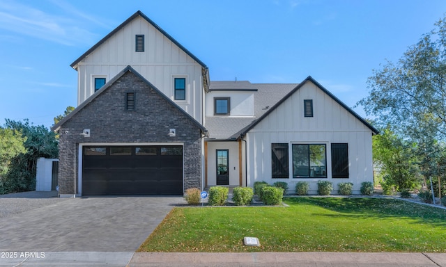 modern farmhouse style home featuring a front yard and a garage