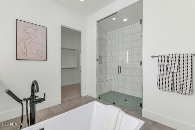 bathroom with tile patterned floors and independent shower and bath