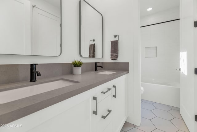 full bathroom featuring tile patterned floors, toilet, vanity, and tiled shower / bath