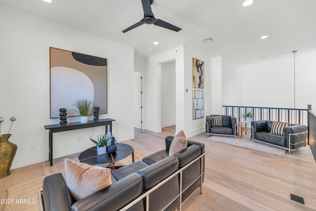 living room featuring ceiling fan and light hardwood / wood-style flooring