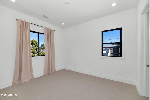 spare room featuring light colored carpet