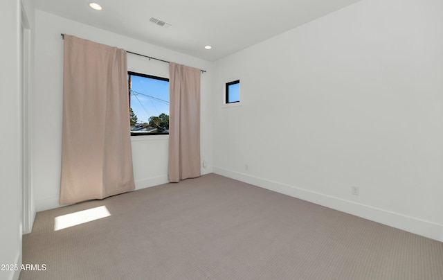 spare room featuring light colored carpet