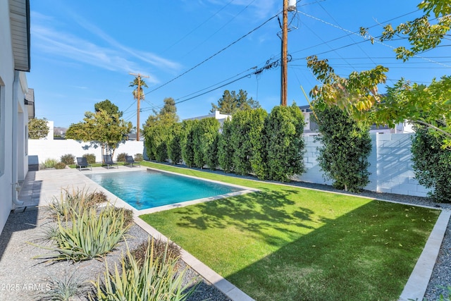 view of swimming pool with a patio and a yard