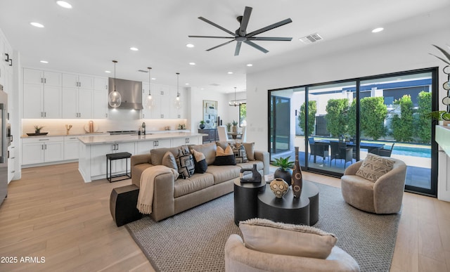 living room featuring ceiling fan and light wood-type flooring