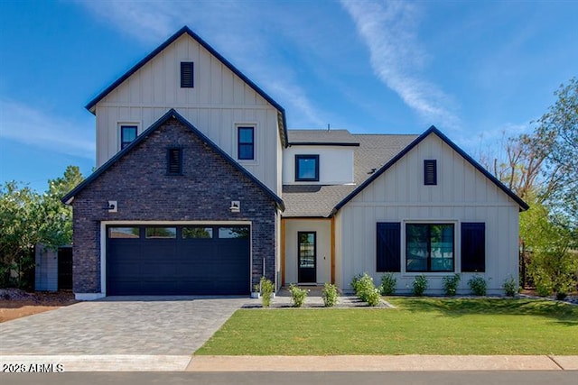 modern inspired farmhouse featuring a front lawn and a garage