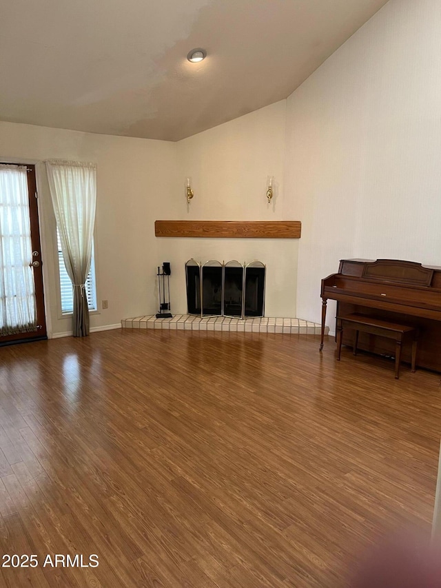 6223 N 12th St Unit 1, Phoenix, AZ 85014 - living room with wood finished floors, a fireplace, and lofted ceiling