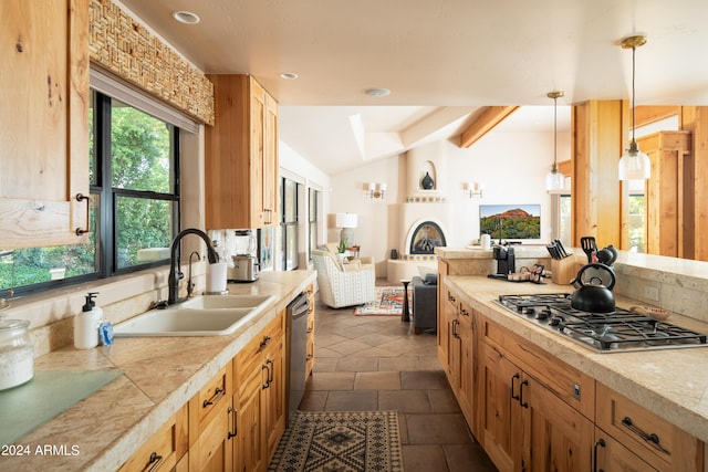 kitchen featuring decorative light fixtures, stainless steel appliances, dark tile patterned floors, and sink