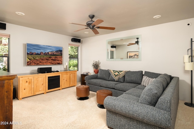 living room featuring ceiling fan and light colored carpet