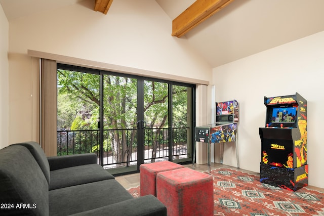 living room with beam ceiling, a healthy amount of sunlight, and high vaulted ceiling