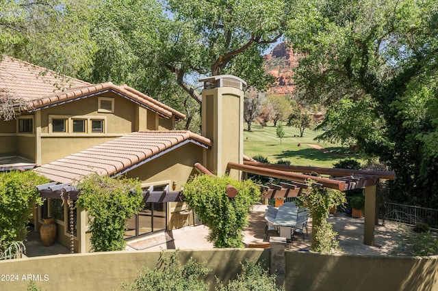 surrounding community featuring a patio area and a pergola