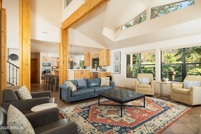 living room with high vaulted ceiling and tile patterned floors