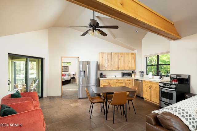 kitchen with beamed ceiling, stainless steel appliances, light brown cabinetry, and sink