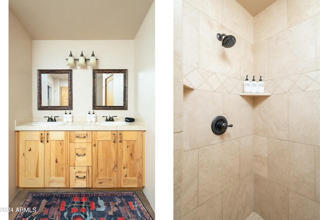 bathroom featuring a tile shower and vanity